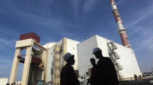 Iranian workers stand in front of Bushehr nuclear power plant, 1,200 km south of Tehran