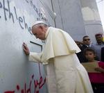 Pope_Francis_touches_the_wall_that_divides_Israel_25.5.14