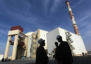 Iranian workers stand in front of Bushehr nuclear power plant, 1,200 km south of Tehran
