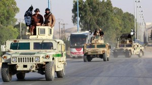 Militant Islamist fighters take part in a military parade along the streets of Raqqa