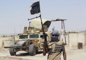 A fighter of the Islamic State of Iraq and the Levant (ISIL) stands guard at checkpoint near the city of Biji