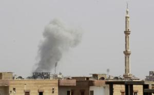 Smoke rises after what activists said was an air raid by Syrian government forces at the eastern Syrian city of Raqqa