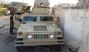 A man looks at a vehicle belonging to the Iraqi security forces in the Anbar province town of Hit