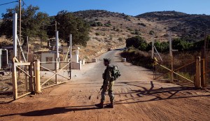 An Israeli soldier stands guard at a check point near the Lebanese-Israeli border, southern Lebanon