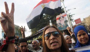 Egyptian woman gestures during a protest against what they say is Qatar's backing of ousted Egyptian president Mohamed Mursi's government, outside the Qatari Embassy in Cairo
