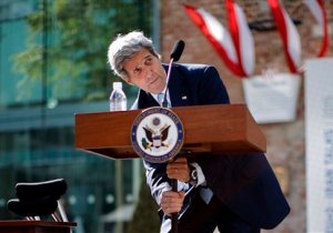 U.S. Secretary of State John Kerry tries to adjust a podium as he delivers a statement on the Iran talks in Vienna, Austria, Sunday, July 5, 2015. Secretary of State John Kerry says negotiations with Iran could go either way ó cutting off any potential path for an Iranian nuclear bomb or ending without agreement. Speaking in Vienna on the ninth day of the nuclear talks, Kerry says disagreements remain on several significant issues. He says hard choices must be made for a deal to be made by Tuesday, the latest deadline. (Leonhard Foeger/Pool photo via AP)