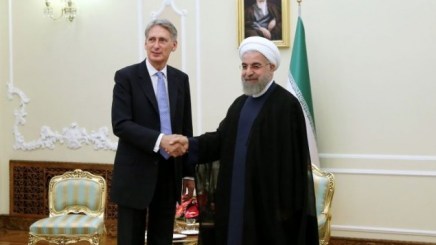 Iran's President Hassan Rouhani, right, welcomes British Foreign Secretary Philip Hammond at the start of their meeting in his office, in Tehran, Iran, Monday, Aug. 24, 2015. (AP Photo/Ebrahim Noroozi)