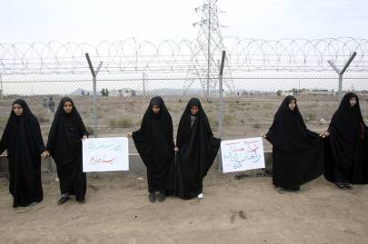 Iranian students in a November 2013 demonstration defending their country's nuclear program outside the Fordow Uranium Conversion facility in Iran.