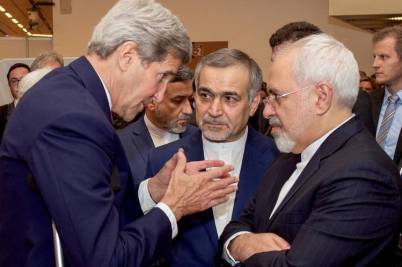 Secretary of State John Kerry, left, huddled with Iranian officials, including Hossein Fereydoun, center, the brother of Iranian President Hassan Rouhani, and Iranian Foreign Minister Javad Zarif, right, before addressing a news conference about a nuclear agreement reached in Vienna in July.