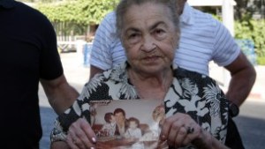 82-year-old Nina Keren, mother of Danny Haran and grandmother of Einat who were killed by Samir Kuntar when he broke into their Nahariya home in 1982 and shot them, holds a picture of her son and her granddaughter on July 15, 2008. ( Kobi Gideon / FLASH90)