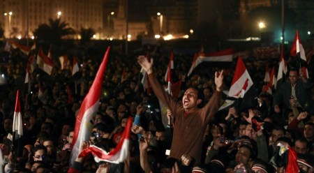 In this Feb. 11, 2011 file photo, Egyptians celebrate the news of the resignation of President Hosni Mubarak, who handed control of the country to the military, at night in Tahrir Square in downtown Cairo, Egypt.(AP Photo/Ben Curtis)