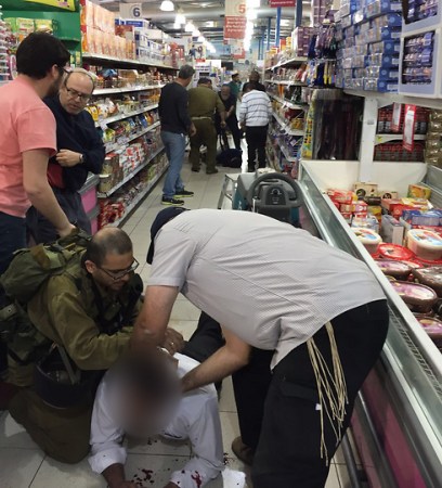 One of the wounded being treated at the scene of the attack (Photo: Uziel Vatik)