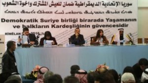 Aldar Khalil (C),from the Movement for a Democtratic Society, and Sheikh Hamad Sheikh Shihadeh (R), the Naim clan chief in northern Syria, speak during a meeting of more than 150 delegates from Kurdish, Arab, Assyrian and other parties in the town of Rmeilan, in Syria's northeastern Hasakeh province, on March 16, 2016.(AFP / DELIL SOULEIMAN)