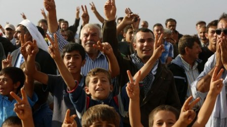 Turkish Kurds shout slogans in support of Syrian Kurdish fighters on the other side of the border near Suruc, Turkey, Wednesday, Sept. 24, 2014. (photo credit: AP/Burhan Ozbilici)
