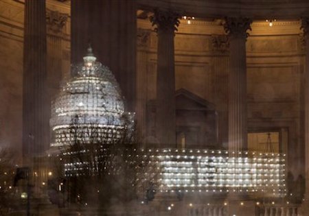 The Capitol in Washington is illuminated during a thunderstorm with the rotunda of the Russell Senate Office Building reflected on the rain-covered windows, late Wednesday afternoon, Feb. 24, 2016. (AP Photo/J. Scott Applewhite)