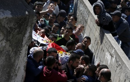 Palestinian mourners attend the funeral of Eyad Omar Sajdia, 22, who was killed during clashes with Israeli security forces at the Qalandya Refugee camp on March 1, 2016 in the Israeli-occupied West Bank. Two Israeli soldiers said to be using a traffic app mistakenly entered the refugee camp in the occupied West Bank overnight, sparking clashes that killed one Palestinian and wounded 15 people, officials said. / AFP / ABBAS MOMANI