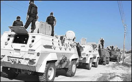Egyptian security forces stand by their Armoured Personell Carriers ahead of a military operation in the northern Sinai peninsula on August 08, 2012. Egypt, which launched air raids against Islamist militants in Sinai for the first time in decades, faces a tough enemy that has used the peninsula's rugged terrain to evade capture in the past. The military said it deployed Apache helicopter gunships in the strikes that killed 20 "terrorists" in the Sinai village of Tumah, in retaliation for a weekend ambush that cost the lives of 16 soldiers. AFP PHOTO/STRINGERSTRINGER/AFP/GettyImages