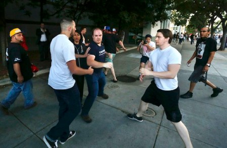 Protesters harass a pair of Trump supporters outside San Jose Convention Center as presidential candidate Donald Trump holds a rally in San Jose, Calif., Thursday, June 2, 2016. (Patrick Tehan/Bay Area News Group)