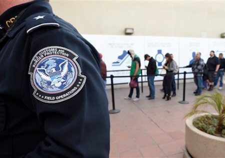 Pedestrians crossing from Mexico into the United States at the Otay Mesa Port of Entry wait in line Thursday, Dec. 10, 2015, in San Diego. On Thursday, U.S. Customs and Border Protection began capturing biometric facial and eye scans of foreigners entering the country at San Diego's Otay Mesa port of entry on foot. (AP Photo/Denis Poroy)