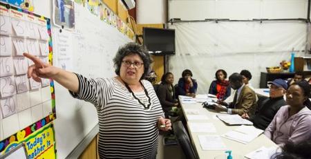 Woman pointing at wall