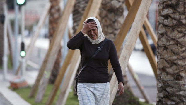 A woman seeking her son near the scene of an attack after a truck drove onto the sidewalk and plowed through a crowd of revelers watching the Bastille Day fireworks in Nice, France, July 15, 2016. (AP/Luca Bruno)