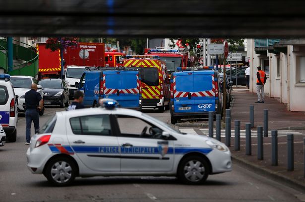 The armed stand-off last around one hour French police vehicles and firemen arrive at the scene of a hostage-taking at a church in Saint-Etienne-du-Rouvray, northern France