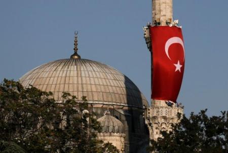 A Turkish flag is seen next to the dome of Hagia Sophia mosque in Istanbul, Turkey, July 16, 2016. REUTERS/Alkis Konstantinidis