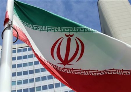 An Iranian flag flies in front of the building where closed-door nuclear talks take place in Vienna, Austria, Wednesday, July 2, 2014. (AP Photo/Ronald Zak)