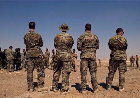 FILE - In this Monday, June 17, 2013 file photo, U.S. special operations forces watch a rehearsal by special operations forces from Iraq, Jordan, and Lebanon as part of Eager Lion, a multinational military exercise in Zarqa, Jordan. The government-owned Al-Rai newspaper says a Jordanian policeman opened fire on American contractors at a police training center, killing two and injuring three. (AP Photo/Maya Alleruzzo, File)