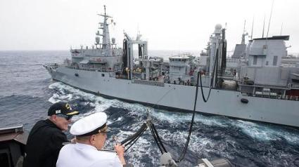 Secretary of the Navy Ray Mabus (L) observes an underway replenishment with Adm. Giuseppe De Giorgi, chief of the Italian navy, while aboard the guided-missile destroyer USS Mason (DDG 87).