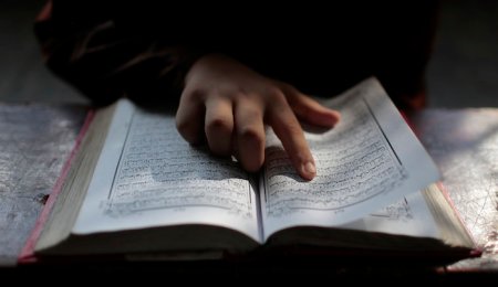 A Bangladeshi Muslim student reads the holy Quran at an Islamic school during Ramadan in Dhaka, Bangladesh, Wednesday, June 29, 2016. Muslims throughout the world are marking the holy month of Ramadan, during which they fast from dawn till dusk. (AP Photo/A.M. Ahad)