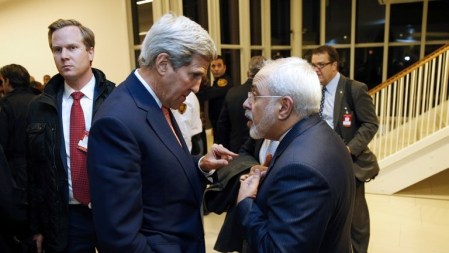 US Secretary of State John Kerry (left) speaks with Iranian Foreign Minister Mohammad Javad Zarif after the UN atomic watchdog verifies that Iran has met all conditions of the July 2015 nuclear deal, in Vienna, Austria, on January 16, 2016. (AFP/Kevin Lamarque/Pool) 