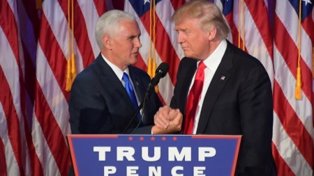 Republican president-elect Donald Trump (R) shakes hands with his running mate Mike Pence at the New York Hilton Midtown in New York on November 9, 2016. (AFP PHOTO/JIM WATSON)