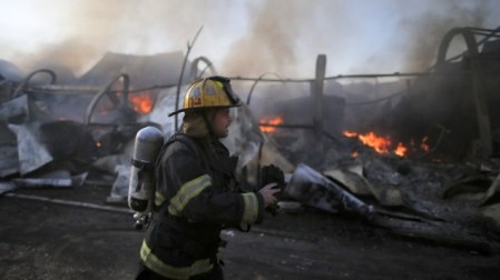 An Israeli firefighter inspects the damage at Beit Meir in the Jerusalem hills, on November 25, 2016. (AFP PHOTO/AHMAD GHARABLI) An Israeli firefighter inspects the damage at Beit Meir in the Jerusalem hills, on November 25, 2016. (AFP PHOTO/AHMAD GHARABLI)