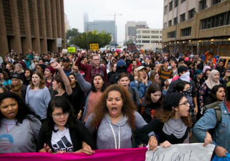 Hundreds of anti-Trump protesers march along Lavaca Street in Austin, Texas, on Wednesday November 9, 2016. (AP Photo/Austin American-Statesman, Jay Janner)