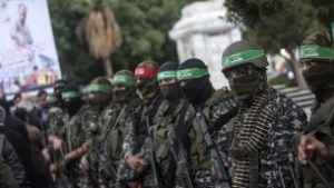 Members of the Izz ad Din al-Qassam Brigades, Hamass military wing, take part in a ceremony, on December 18, 2016, in Gaza City in the memory of one of their leaders, Mohamed Zaouari, who was murdered in Tunisia. (AFP/Mahmud Hams)