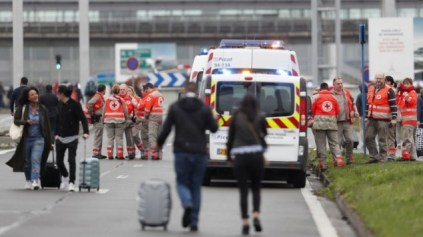 French Red Cross workers stand by as travelers are evacuated from Paris' Orly airport on March 18, 2017 following the shooting of a man by French security forces. (Benjamin CREMEL)