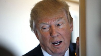President Donald Trump speaks with reporters on Air Force One while in flight from Andrews Air Force Base, Md., to Palm Beach International Airport, Fla., Thursday, April 6, 2017. (AP Photo/Alex Brandon)