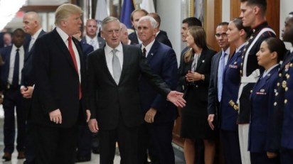 President Donald Trump and Vice President Mike Pence walk with Defense Secretary Jim Mattis, center, to begin greeting military personnel during their visit to the Pentagon, Thursday, July 20, 2017. (AP Photo/Pablo Martinez Monsivais)