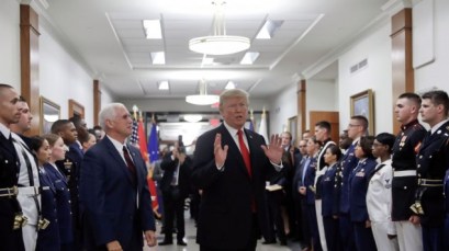 President Donald Trump stops to answer a reporter's question after greeting military personnel during a visit to the Pentagon, Thursday, July 20, 2017. Watching is Vice President Mike Pence. (AP Photo/Pablo Martinez Monsivais)