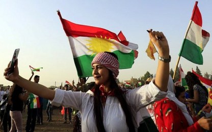 A Syrian Kurd takes a selfie, in the northeastern Syrian city of Qamishli on September 26, 2017, during a gathering in support of the independence referendum in Iraq's autonomous northern Kurdish region. ( AFP/ Delil souleiman)