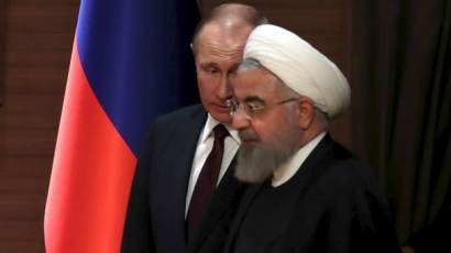 Russian President Vladimir Putin and his Iranian counterpart Hassan Rouhani arrive for a joint news conference after their meeting in Ankara, Turkey April 4, 2018
