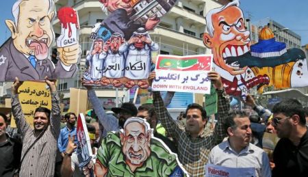 Iranian protesters hold up caricatures of leaders of Israel during the annual anti-Israeli Al-Quds, Jerusalem, Day rally in Tehran, Iran, Friday, June 8, 2018.