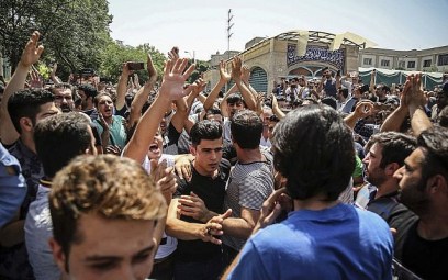 A group of protesters chant slogans at the main gate of old Grand Bazaar in Tehran, Iran, June 25, 2018. (Iranian Labor News Agency via AP)