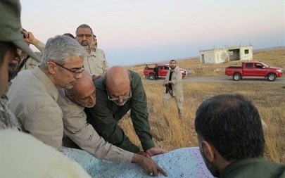 This file photo provided on Friday October 20, 2017 by the government-controlled Syrian Central Military Media, shows Iran's army chief of staff Maj. Gen. Mohammad Bagheri, left, looking at a map with senior officers from the Iranian military as they visit a front line in the northern province of Aleppo, Syria. (Syrian Central Military Media, via AP, File)
