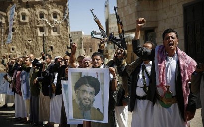 FILE - In this March 3, 2016 photo, Shiite rebels, known as Houthis, hold a poster of Hezbollah leader Sheikh Hassan Nasrallah during a rally in support of Hezbollah, in Sanaa, Yemen. (AP Photo/Hani Mohammed, File)