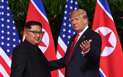 US President Donald Trump (R) gestures as he meets with North Korea's leader Kim Jong Un (L) at the start of their historic US-North Korea summit, at the Capella Hotel on Sentosa island in Singapore on June 12, 2018. (AFP/Saul Loeb)