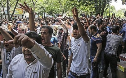 A group of protesters chant slogans at the old grand bazaar in Tehran, Iran, Monday, June 25, 2018. Protesters in the Iranian capital swarmed its historic Grand Bazaar on Monday, news agencies reported, and forced shopkeepers to close their stalls in apparent anger over the Islamic Republic's troubled economy, months after similar demonstrations rocked the country. (Iranian Labor News Agency via AP)