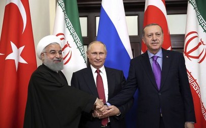 Turkey's President Recep Tayyip Erdogan, (r), Russia's President Vladimir Putin, (c), and Iran's President Hassan Rouhani pose for the media members in Sochi, Russia, November 22. 2017. (Kayhan Ozer/Pool via AP)