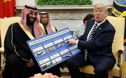 US President Donald Trump shows a chart highlighting arms sales to Saudi Arabia during a meeting with Saudi Crown Prince Mohammed bin Salman in the Oval Office of the White House, March 20, 2018, in Washington. (AP Photo/Evan Vucci)